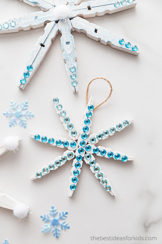 Craft wooden snowflakes from clothespins painted with white color, reusable  DIY New Year ornament Stock Photo by maria_symchychnavr