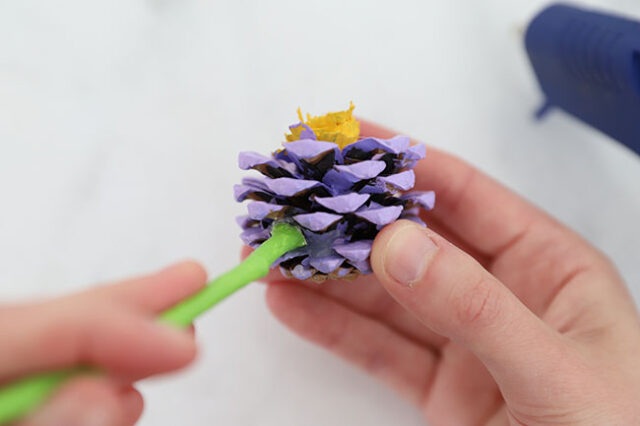 Hot gluing stick to pine cone