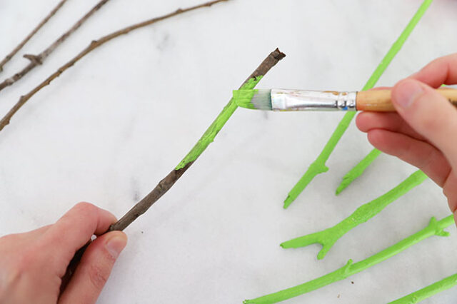 Painting sticks green