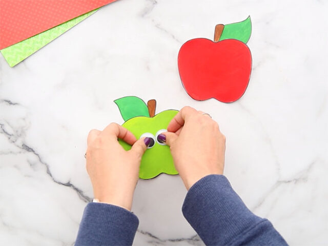 Gluing eyes onto apple