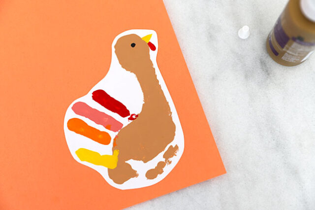 Gluing turkey onto colored paper