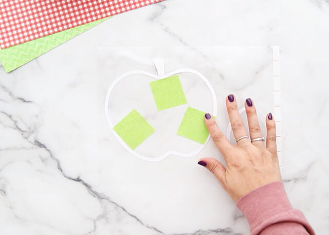 Placing colored tissue onto laminating sheet