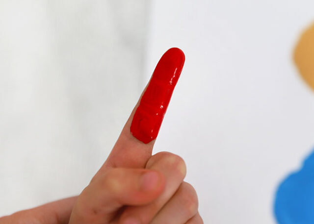 Red paint on finger