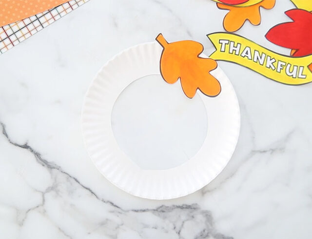 Cut out paper plate to make wreath