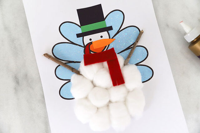 Stick arms on snowman