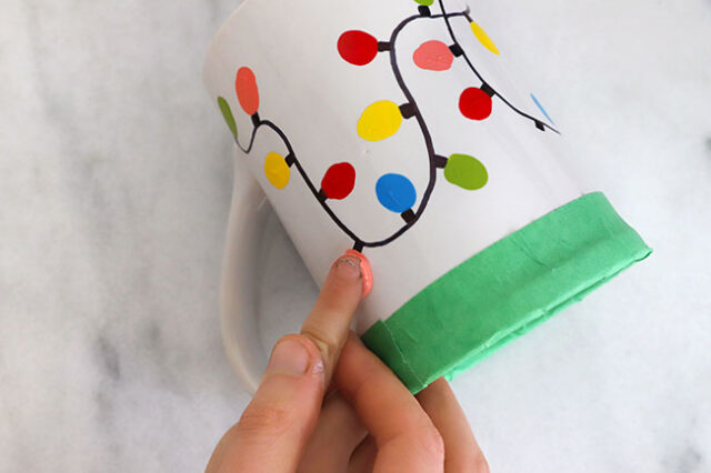 Finger stamping bulb onto mug