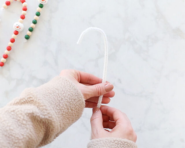 Shaping pipe cleaner into candy cane