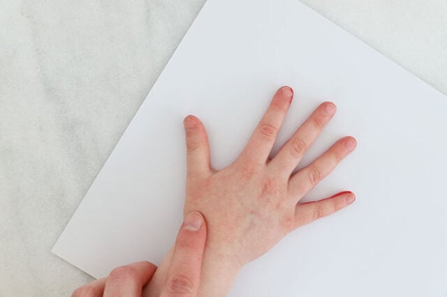 Stamping hand onto paper